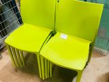 two yellow chairs sitting next to each other in a store