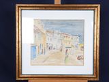 framed watercolor painting of a street scene with a woman walking down the street