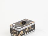 a black and gold marble box sitting on top of a white surface