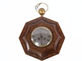 une horloge en bois accrochée au mur sur un fond blanc