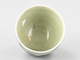 a small white bowl sitting on a white surface
