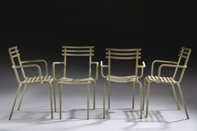 three chairs and a table in a room with a black background