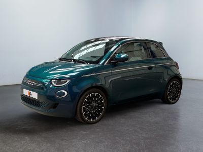 a blue smart car parked in a room with a white wall