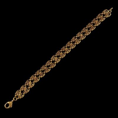 a close up of a gold chain bracelet on a black background