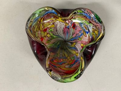 a heart shaped glass bowl with a colorful design on it