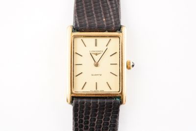 a close up of a watch on a white surface