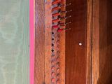 a wooden cabinet that has a bunch of knives in it