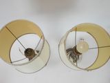 pair of two lamps on a white surface with one light turned off