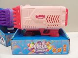 purple and pink bubble blower gun sitting on top of a blue box