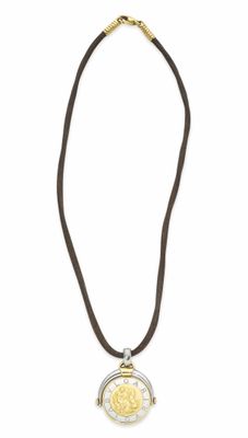 a close up of a necklace with a coin on it