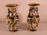 two vases that are sitting on a table