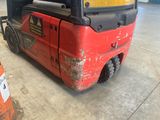 a red forklift truck parked in a warehouse
