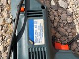 a drill on the ground with a cord attached to it