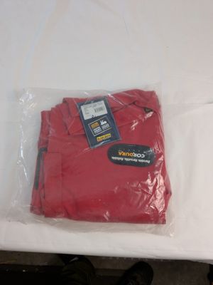 a red t - shirt in a plastic bag on a table