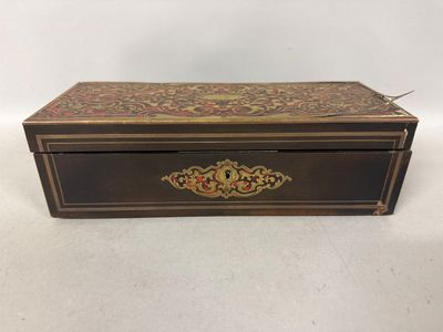 a wooden box with a gold and red design on it