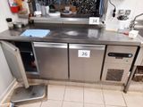 a stainless steel counter with a sink and a refrigerator