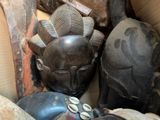 many different types of african masks in a box