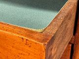 a wooden desk with a drawer on top of it
