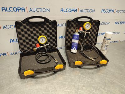 two air compressors in a case with a hose and a pressure gauge
