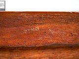 a close up of a wooden bench with writing on it