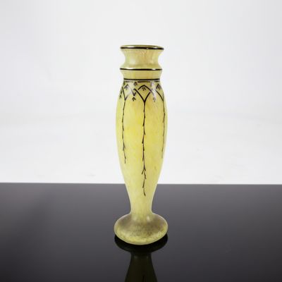 a yellow vase that is sitting on a black table