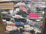 a metal cage filled with assorted items in a warehouse