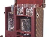 a suitcase with a wine bottle and glasses inside of it