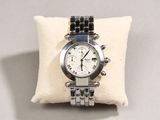 an image of a watch sitting on a pillow on a table