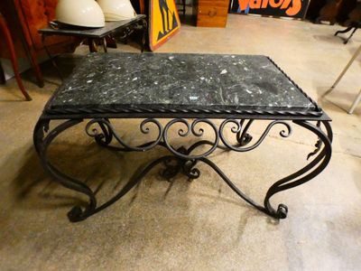 a black table with a marble top in a room