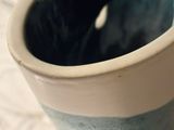 a blue and white vase sitting on a table