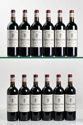 several bottles of wine are lined up on a glass shelf