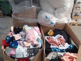 two boxes of clothes and a teddy bear in the middle of the street