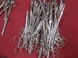several pairs of scissors are laying on a red surface