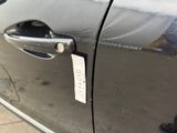 a close up of a car door handle with a sticker on it