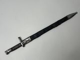 a close up of a knife on a white surface with a black handle