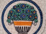 a plate with a flower pot on it on a table