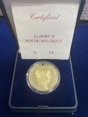 a close up of a gold coin in a box on a table