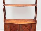 an old wooden bookcase with two doors and a shelf