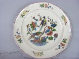 a plate with a bird and flowers on it