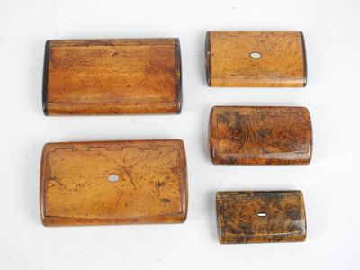 four pieces of wood are arranged in a row on a white surface