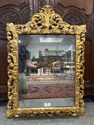 a mirror that is sitting on the floor in front of a wall