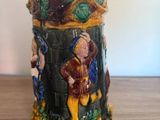 a ceramic mug with a picture of a man and a woman on it