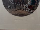 a picture of a man on a horse with a group of dogs in the background