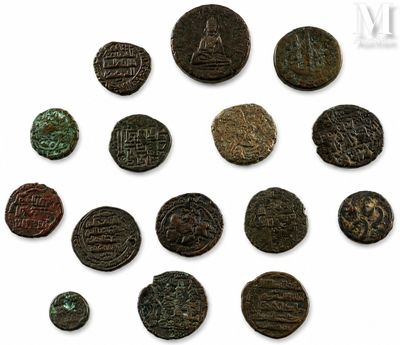 a close up of a group of ancient coins on a white surface