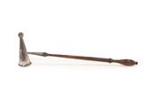 an old metal pipe with a wooden handle sitting on a white surface