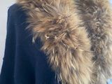 a black sweater with a fur collar on a mannequin mannequin