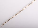 a close up of a gold chain on a white background