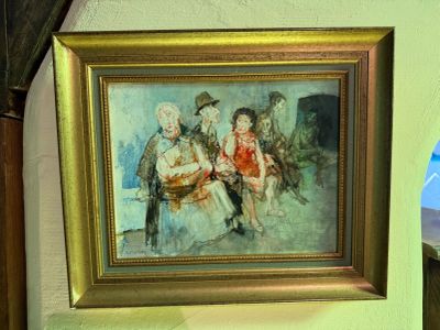 a picture of a painting hanging on a wall next to a lamp