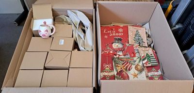 two boxes of christmas cards and a cup of coffee on the table