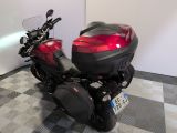 a red motorcycle parked in a room with a checkered floor